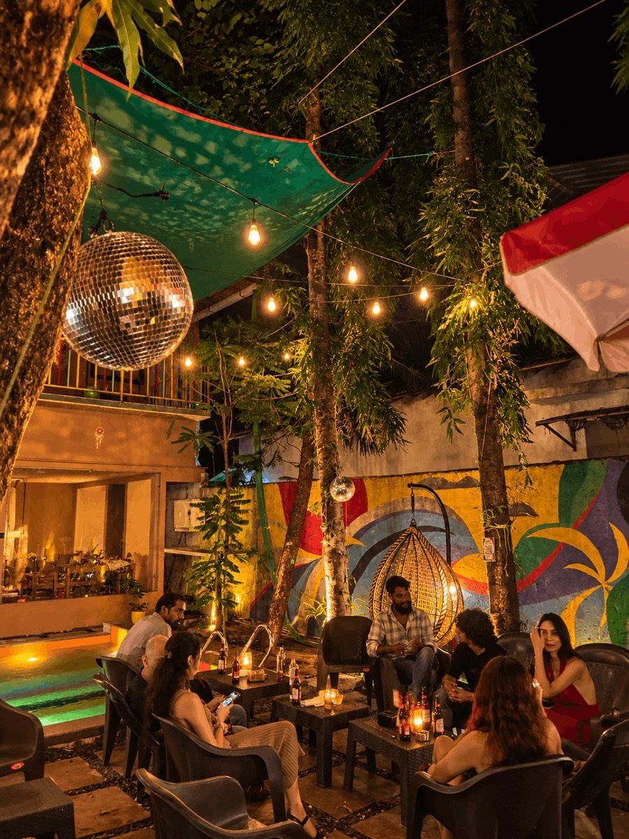 Friends gathering beneath courtyard lights